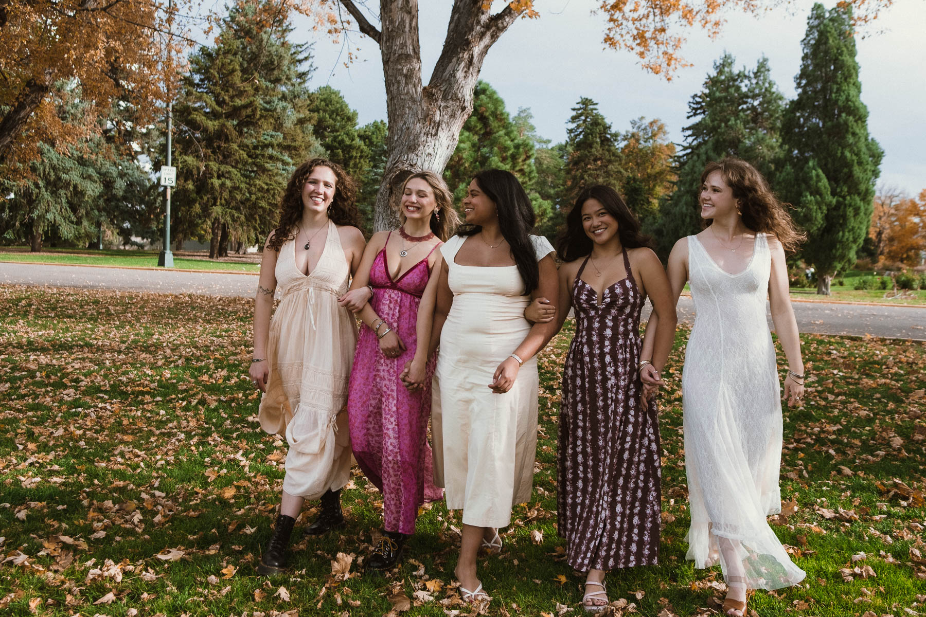 Group of friends laughing together in autumn park setting